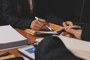 Business people working at a desk with a pen and paper photo