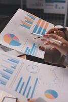 Business people looking at graphs and papers photo