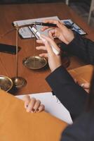 Business people working on a desk with a scale photo