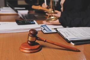 Lawyer and judge sitting at a desk with a gavel and a laptop photo
