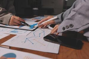 Business people working on graphs and papers photo