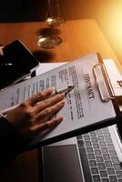 Contracts and legal documents on a desk photo