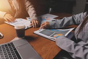 Two business people working on papers at a desk photo