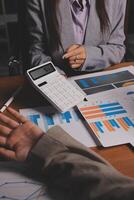 Business people working on a business plan photo