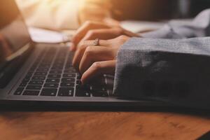 A person typing on a laptop computer photo
