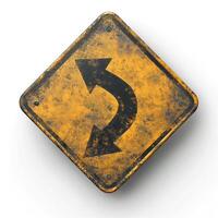 An aged yellow traffic sign indicating a U-turn, featuring a worn and rustic appearance. photo