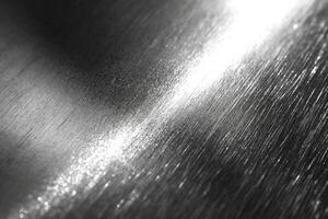 Close-up of polished metal surface showing reflections and intricate texture. photo