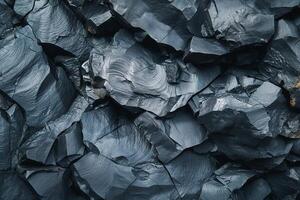 A close-up of textured dark slate rock formations showcasing unique patterns and colors. photo