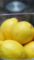 fresh lemons in a glass bowl at a bar, with a variety of bottles in the background, capturing a vibrant and refreshing scene video