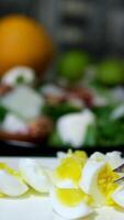 The cook cuts an egg on a grater. video