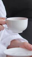girl drinking tea in sauna sheet and relaxes on soft chaise longue in the spa zone. Slow motion video