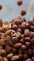 almond and hazelnut Nuts falling glass bowl Nuts gently cascading into a jar of creamy nut butter, culinary project. Natural flavors and textures captured with burlap background video