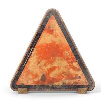 A weathered triangular warning sign with a faded orange surface and black border, indicating caution or danger. photo