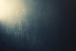 A textured gradient of dark blues and subtle light, creating a moody, abstract background. photo