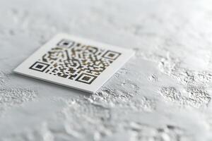 Close-up of a QR code on textured gray surface, representing modern technology and connectivity. photo