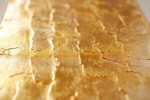 Elegant golden textured surface with intricate crack patterns, adding a luxurious touch to any design. photo