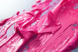 Close-up of vibrant pink paint swirls, showcasing texture and gloss. photo
