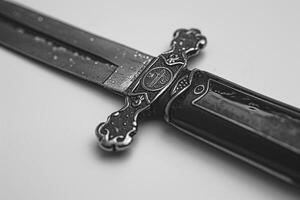 Close-up of an ornate, wet dagger with intricate details and a gleaming blade. photo