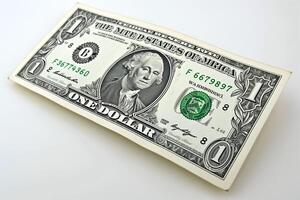 A close-up of a one dollar bill featuring George Washington's portrait, symbolizing currency and commerce. photo