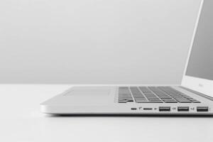 A sleek silver laptop viewed from the side, showcasing its minimalist design and multiple ports. photo