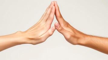 Two hands, one light and one dark, gently touch in a harmonious gesture of unity and connection. photo