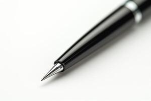 Close-up of a sleek black ballpoint pen, showcasing its elegant design and shiny chrome tip. photo