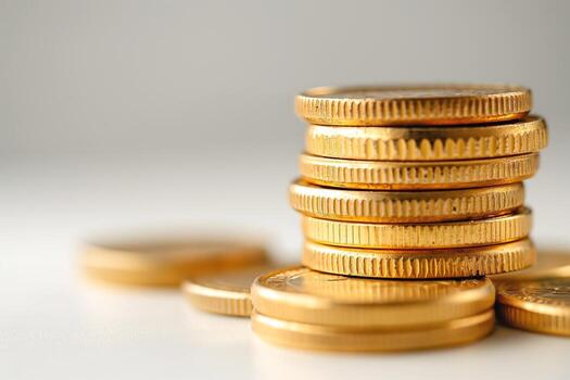 A close-up of stacked golden coins illuminated in soft light, symbolizing wealth and prosperity. photo