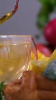 honey in tea Cup of hot tea with ginger root, lemon and honey. Adding natural raw honey to cup of hot tea. Vitamin C drink, immune system boost video