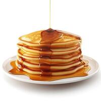 A stack of fluffy pancakes topped with warm syrup, served on a white plate, perfect for breakfast. photo