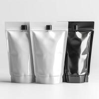 Three stylish pouches in black, white, and silver colors, perfect for packaging cosmetics or food products. photo