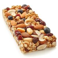Close-up of a delicious granola bar topped with mixed nuts and dried fruits, perfect for a healthy snack. photo