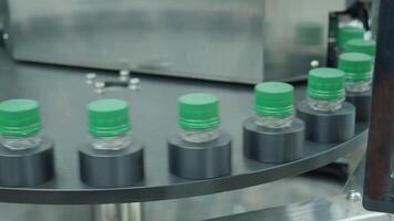 Close up view of a plastic bottle production line in a factory. Parts of transparent PET bottles move along an automated conveyor system. Showing modern PET drinking bottles manufacturing automations. video