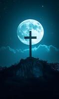 The cross on a hilltop with a full moon and stars shines in the serene night sky photo