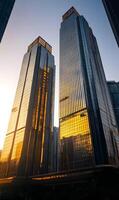 Modern skyscrapers reflecting sunlight against clear blue sky in urban metropolis photo