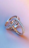 Elegant intertwined diamond wedding rings in warm and cool tones with soft gradient backdrop photo