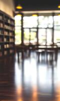 Abstract library background showcases bookshelves and reading areas in artistic blur effect photo