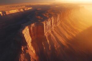 Sun shining on the edge of a canyon in a desert landscape photo