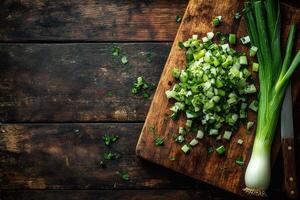 Chopped spring onions and parsley resting on rustic wooden cutting board photo