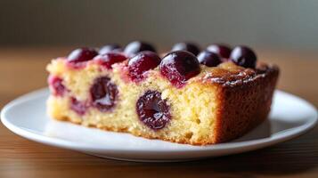 Slice of delicious cherry clafoutis cake resting on white plate photo