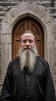 A bearded man with a long beard standing in front of a door photo