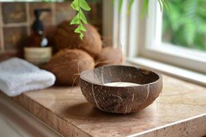 A coconut shell bowl with a candle on a marble countertop photo