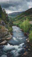 A river runs through a forest and mountains photo