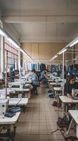 A factory with people working on sewing machines photo