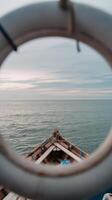 A view of the ocean through a circular porthole photo