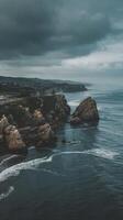 A view of the ocean and rocks on a cloudy day photo