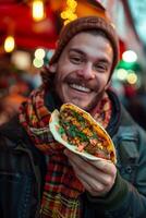 A man is holding a taco photo