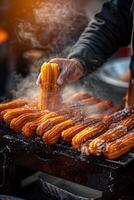 A person is cooking some hot dogs on a grill photo