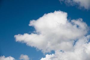 Beautiful blue sky with white fluffy big clouds photo