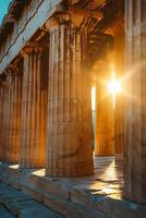 The sun shines through the pillars of an ancient greek temple photo