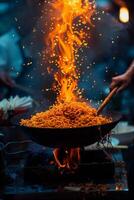 A person stirring a pot of food with fire photo